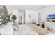Inviting main bedroom with an ornate bed frame, hardwood floors, and TV at 113 Seahorse Se Dr # D, St Petersburg, FL 33705