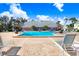 Community pool area featuring a swimming pool, lounge chairs and clubhouse at 113 Seahorse Se Dr # D, St Petersburg, FL 33705