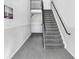 Clean and modern staircase featuring neutral carpeting, leading to the upper level of the residence at 113 Seahorse Se Dr # D, St Petersburg, FL 33705
