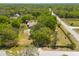 A high angle aerial shot shows how the property is situated in a neighborhood full of green trees at 11434 Minnieola Dr, New Port Richey, FL 34654