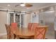 Dining area with a large table, six chairs, and sliding barn doors to a pantry at 11434 Minnieola Dr, New Port Richey, FL 34654