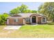 Charming single-story home with a well-manicured lawn and a classic front facade, showcasing curb appeal at 11434 Minnieola Dr, New Port Richey, FL 34654