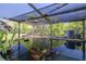 Screened koi pond with clear water and colorful fish, perfect for relaxation and a unique outdoor feature at 11434 Minnieola Dr, New Port Richey, FL 34654