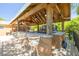 Outdoor kitchen featuring a bar area, multiple grills, and counter seating, perfect for entertaining guests at 11434 Minnieola Dr, New Port Richey, FL 34654