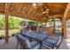 Covered outdoor kitchen and dining area with seating for six, perfect for entertaining guests at 11434 Minnieola Dr, New Port Richey, FL 34654