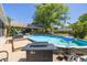 Relaxing backyard pool area with a covered outdoor kitchen, inviting you to enjoy the outdoors at 11434 Minnieola Dr, New Port Richey, FL 34654