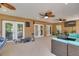 Covered porch featuring comfortable seating and views of the outdoor pool and backyard at 11434 Minnieola Dr, New Port Richey, FL 34654