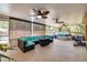 Spacious sunroom featuring comfortable turquoise seating and views of the outdoor pool and lush backyard at 11434 Minnieola Dr, New Port Richey, FL 34654