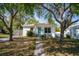 Charming home with a teal front door, mature trees, and a well-maintained front yard at 1225 9Th S Ave, St Petersburg, FL 33705