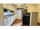 Bright kitchen features white cabinets, granite countertops and stainless steel appliances at 1301 S Hercules Ave # 3, Clearwater, FL 33764