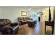 Living room features hardwood floors, ceiling fan, and updated furniture at 1301 S Hercules Ave # 3, Clearwater, FL 33764