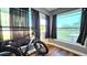 Bright sitting room with a large window, hardwood floors, and black curtains at 1301 S Hercules Ave # 3, Clearwater, FL 33764