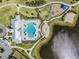 An aerial view of community pool, splash pad, playground, lake, and gathering areas at 13549 Willow Bluestar Loop, Riverview, FL 33579
