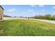 Expansive backyard with lush green grass and a privacy fence, perfect for outdoor activities at 13549 Willow Bluestar Loop, Riverview, FL 33579