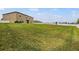 Large backyard with green grass and perimeter fencing at 13549 Willow Bluestar Loop, Riverview, FL 33579
