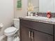 Cozy bathroom with a dark vanity and granite countertop at 13549 Willow Bluestar Loop, Riverview, FL 33579