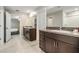 Well-lit bathroom with double vanities and granite countertops at 13549 Willow Bluestar Loop, Riverview, FL 33579