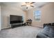 Large carpeted room with a ceiling fan and a window at 13549 Willow Bluestar Loop, Riverview, FL 33579