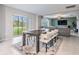 Open dining area connects to the living room with sliding glass doors that provide a view of the backyard at 13549 Willow Bluestar Loop, Riverview, FL 33579