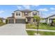 Charming two-story home boasts a two-car garage, well-maintained lawn, and welcoming curb appeal at 13549 Willow Bluestar Loop, Riverview, FL 33579