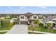 Beautiful two-story home featuring a three-car garage and well-manicured lawn at 13549 Willow Bluestar Loop, Riverview, FL 33579