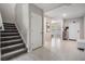 Inviting foyer with staircase and view of the dining area at 13549 Willow Bluestar Loop, Riverview, FL 33579