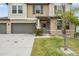 Close-up of home's entrance highlighting the front door, small garden, and three-car garage at 13549 Willow Bluestar Loop, Riverview, FL 33579