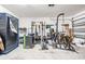 Spacious garage equipped with home gym and fitness equipment at 13549 Willow Bluestar Loop, Riverview, FL 33579