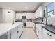 Modern kitchen featuring white cabinets, a large island, and stainless steel appliances at 13549 Willow Bluestar Loop, Riverview, FL 33579