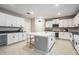 Bright kitchen boasts a large center island with seating, modern appliances, and sleek white cabinetry at 13549 Willow Bluestar Loop, Riverview, FL 33579