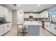 Modern kitchen featuring white cabinets, a large island with seating, stainless steel appliances, and a stylish backsplash at 13549 Willow Bluestar Loop, Riverview, FL 33579