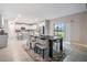 Bright, open kitchen with an island, stainless steel appliances, and a view of the backyard through a sliding glass door at 13549 Willow Bluestar Loop, Riverview, FL 33579