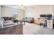 Spacious living room with a sofa and desk at 13549 Willow Bluestar Loop, Riverview, FL 33579