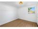 Bright bedroom featuring wood-look flooring, a window, and modern lighting at 14831 56Th N St, Clearwater, FL 33760