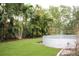 Inviting backyard with lush greenery, a modern above-ground pool, and mature trees at 1519 Delaware Ne Ave, St Petersburg, FL 33703