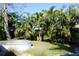 Lush backyard featuring a pool and tropical landscaping at 1519 Delaware Ne Ave, St Petersburg, FL 33703