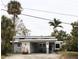 Inviting single-story home with an attached carport, complemented by lush tropical landscaping at 1519 Delaware Ne Ave, St Petersburg, FL 33703