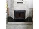 Elegant fireplace with a stone surround and black mantle, ready to become a focal point at 1519 Delaware Ne Ave, St Petersburg, FL 33703