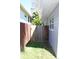 Cozy side yard featuring a wooden fence, fresh lawn, and access to the house's side entrance at 1519 Delaware Ne Ave, St Petersburg, FL 33703