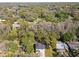 An overhead shot showing a cozy home nestled among the surrounding trees at 16417 Lake Byrd Dr, Tampa, FL 33618