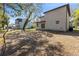 Backyard with mature trees, neighboring home, and patio doors at 16417 Lake Byrd Dr, Tampa, FL 33618