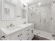 Modern bathroom with double vanity, framed mirrors, and a glass shower at 16417 Lake Byrd Dr, Tampa, FL 33618
