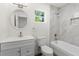 A stylish bathroom with a white vanity, tub, and marble tile surround at 16417 Lake Byrd Dr, Tampa, FL 33618