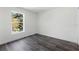 A minimalist bedroom with a large window overlooking greenery at 16417 Lake Byrd Dr, Tampa, FL 33618