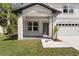 Inviting front porch with classic archway and stylish door, complemented by fresh landscaping at 16417 Lake Byrd Dr, Tampa, FL 33618