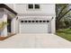 Attached two-car garage with white door on a modern-style home at 16417 Lake Byrd Dr, Tampa, FL 33618