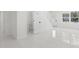 Hallway leading to the bathroom, staircase and front door, and window with outside view at 16417 Lake Byrd Dr, Tampa, FL 33618