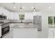 Bright and open kitchen featuring granite counters, stainless appliances, and modern lighting at 16417 Lake Byrd Dr, Tampa, FL 33618