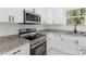 Kitchen with granite counters, stainless appliances, and white cabinets at 16417 Lake Byrd Dr, Tampa, FL 33618