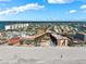 Wide aerial view captures the building's waterfront location with beach access, and nearby residential neighborhoods at 17580 Gulf Blvd # 316, Redington Shores, FL 33708